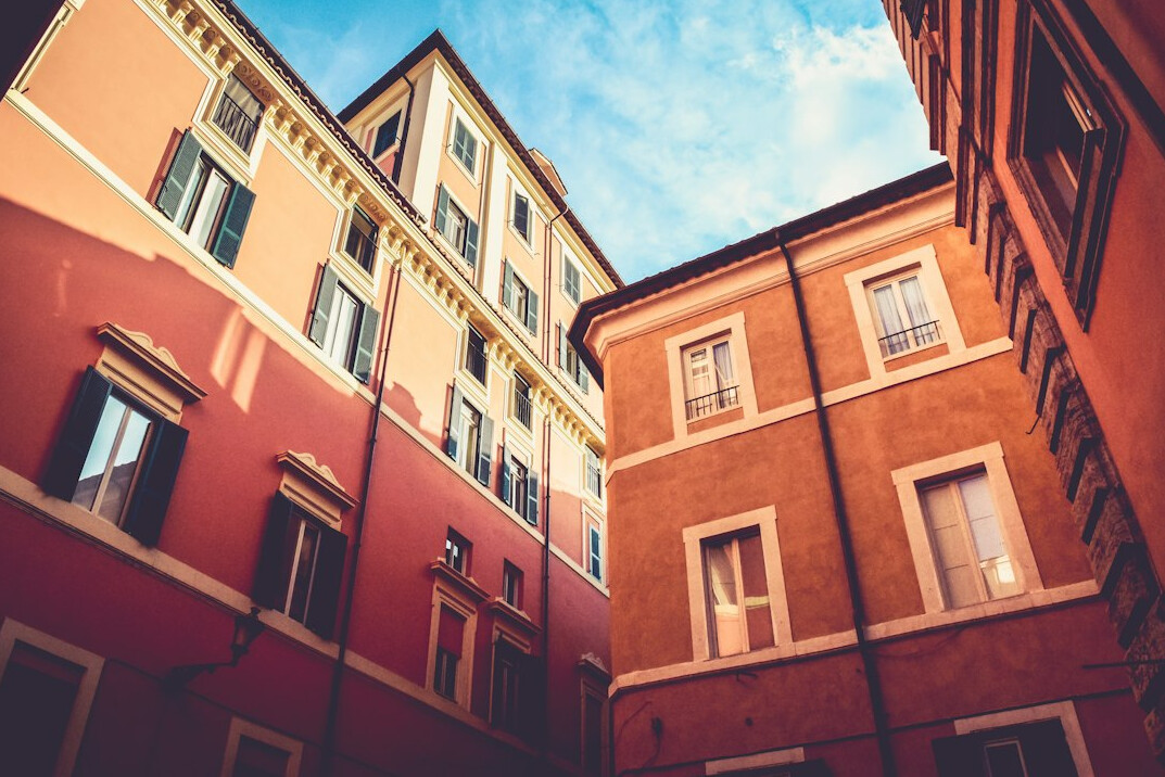 Assorted-color historic buildings under a blue sky