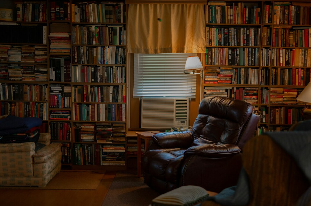 Room filled with books and a warm lamp